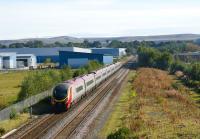 A Pendolino being dragged south on 28 September 2008 past the site of the former Royal Ordnance Factory at Euxton, Lancs (also known as ROF Chorley). The large factory stood to the left of the tracks with office and administrative facilities to the right. The location boasted its own station, opened in 1938 as Chorley ROF Platform and renamed Chorley Halt by 1942. The station was closed by 1963 and subsequently demolished after the majority of the site had been redeveloped for housing and commercial use. Island platform remains can be seen to the right of the tracks on the weed covered mound.<br>
<br><br>[John Mcintyre 28/09/2008]