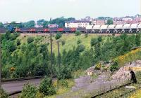 An 08 shunts Ravenscraig No. 3 in 1988 before heading north over the Merry Street bridge. The buffer stop at the bottom right is the reversing spur used to reach the huge scrap yards between Ravenscraig and Dalzell works also used to deliver Concast slabs to DL.<br><br>[Ewan Crawford //1988]