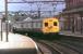 Hadfield 1500v DC EMU with trailer 59605 leading arrives in Guide Bridge from Glossop on a Manchester Piccadilly service on 26 August 1982. The train is passing the signal box controlling the junction with the Stalybridge line and access to the locomotive holding sidings. These platforms at Guide Bridge are now closed and the tracks lifted. Only two of the four original platforms survive although the signal box was still operational in 2012, albeit now some distance from the tracks. <br><br>[Mark Bartlett 26/08/1982]