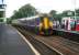 It's Festival time again! An attractive combination of liveries at Livingston South station on 14 August 2008. The train looks nice too - in this case the 1215 Glasgow Central - Edinburgh Waverley service.<br><br>[John Furnevel 14/08/2008]