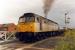 A departure from Felixstowe container depot crosses the road at Felixstowe Beach in 1990.<br><br>[Ewan Crawford //1990]