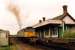 A 47 passes through the well preserved Felixstowe Beach station in 1990 with a container train. The unpreposessing cabin on the left was the signalbox.<br><br>[Ewan Crawford //1990]