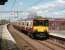 Sunshine on Yoker on 19 April 2008 as 318 256 arrives with a service to Motherwell.<br><br>[David Panton 19/04/2008]