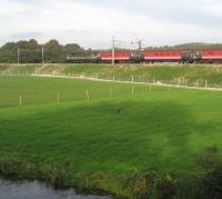 A two-tone green class 47 on the rear of southbound ecs move on the WCML just south of Garstang & Catterall on 12 October 2008. The water in the foreground is the Lancaster Canal.<br><br>[John McIntyre 12/10/2008]