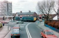 The ungated level crossing at Fawdon with a class 31 on the Rowntrees goods in 1983.  In those days BR freight shared the then Bank Foot branch of the Tyne & Wear Metro, since extended to Newcastle Airport.<br><br>[Colin Alexander //1983]
