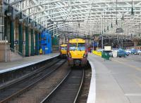 A class 334 has just arrived at Glasgow Central platform 12 with a train from Gourock on 15 October. The car parking area on the right is destined to become an extended version of platform 11a (currently terminating outwith the station arch) following which it will handle trains on the planned Glasgow Airport Rail Link.<br><br>[John McIntyre 15/10/2008]