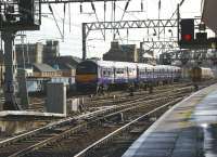 Heading into the sun from Glasgow Central on 15 October, a Class 322 for North Berwick starts its afternoon run to the other side of the country via Carstairs.<br><br>[John McIntyre 15/10/2008]