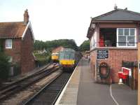 A former Marylebone Class 115 DMU waits by the signal box at Bishops Lydeard for a WSR evening departure to Minehead. The 4-car set is in excellent condition and behind, in the short siding, is preserved BRCW Type 3 D6566/33048. <br><br>[Mark Bartlett 14/09/2008]