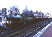 Scene at Lanark on 16 October 1965 with ex-Great North of Scotland Railway 4-4-0 No 49 <I>Gordon Highlander</I> at the head of a Branch Line Society railtour. The old church behind the locomotive has since been demolished and replaced by a modern office block. <br><br>[Robin Barbour Collection (Courtesy Bruce McCartney) 16/10/1965]