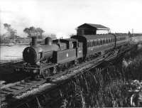 Lancashire and Yorkshire Radial 2-4-2T 50655, and its push pull set, runs into the Holcombe Brook terminus from Bury past the small goods shed and yard. Side contact third rails still in place from the electric service that had ceased the previous year. Undated photo but thought to have been taken on the last weekend of passenger services.<br><br>[W A Camwell Collection (Courtesy Mark Bartlett) 03/05/1952]