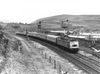 Climbing up to the Standedge tunnel at Diggle is 47415 on a Liverpool to Newcastle service running past the semaphores that were still in use at that time. 3-car Trans Pennnine 185 units provide the services now but on a much more frequent basis than in the 1980s. <br><br>[Mark Bartlett 31/12/1980]