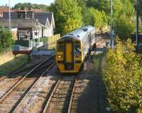 A Bridlington - Sheffield service, formed by Alphaline liveried 158 817, runs over Wansford Road level crossing, Driffield, on 1 October 2008, as it slows on the approach to the station.<br><br>[John Furnevel 01/10/2008]