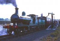 Ex-Great North of Scotland Railway 4-4-0 No 49 <I>Gordon Highlander</I> takes water on the northbound platform at Auchengray with a Branch Line Society railtour on 16 October 1965. On the right is the old bay platform that once served the former Wilsontown branch. The route shown on the ticket was <I>Glasgow Central to Glasgow St Enoch via Ponfeigh, Roslin & Bathgate</I>. <br><br>[Robin Barbour Collection (Courtesy Bruce McCartney) 16/10/1965]