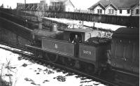 Snow on the ground but the young fireman has his sleeves rolled up so the cab of the L&YR 2-4-2T must be nice and warm. 50731 stands at the Holcombe Brook terminus with the push pull coach in February 1952 after another run up the branch from Bury Bolton St.  <br><br>[W A Camwell Collection (Courtesy Mark Bartlett) 03/02/1952]