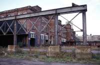 This is the huge edifice that was once Glasgow High Street Goods Station, pictured in October 1984 with six months to go before the demolition teams arrived. Photographing the site was particularly unnerving for two reasons. Firstly, the cavernous structure was full of the ghosts of the hundreds of workers who'd toiled in the building since it was built in 1904. Discarded equipment, paperwork and signage to long closed rail destinations was lying everywhere. Secondly, there appeared to be much more physical presence about in the upper reaches of the building. Not a time to be caught deep in a derelict maze with valuable camera equipment. Either end of the building had a prominent clock at roof level. The station's time had run out one day in March 1982 at 11.15.<br><br>[Mark Dufton 04/10/1984]