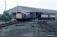 Although the line between King's Lynn and Dereham closed on September 9th 1968, freight activity continued on short sections at either end. This is the Dereham end on September 27th 1983, where 31 220 is collecting UKF fertiliser wagons from the remaining stub of the line. In the right foreground is the former road into platform 4 at Dereham station provided for the King's Lynn service. Along with various other redundant sidings around the station, it was being lifted that day. Other freight facilities were withdrawn two months later, but this fertiliser traffic lasted until the very end of BR use of the line in June 1989.<br><br>[Mark Dufton 27/9/1983]