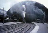 The massive arch of the roof at St Enoch station dwarfs the locomotives below in the Summer of 1965. The line up includes 45432, 45455, 80000 and 45489<br><br>[G W Robin 07/07/1965]