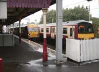 334 022 runs into platform 1 at a wet Milngavie station on 9 August, thus clearing the single line section for the train on platform 2 to depart with a service for High Street.   <br><br>[David Panton 09/08/2008]