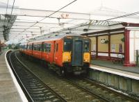 Glasgow Central - Ayr service at Troon in July 1997 formed by 318 254.<br><br>[David Panton /07/1997]