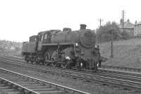 BR Standard Class 4 no 76091 passes Corkerhill shed heading for Glasgow in 1963. Part of the 1896 G&SW Corkerhill Railway Village can be seen in the left background behind the signal box. 76091 moved to Hurlford some months later and was withdrawn from there in December of 1966. End of the road was at Shipbreaking Industries, Faslane, the following April.<br>
<br><br>[Colin Miller //1963]