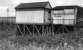 Fifteen months after closure and over two years after electric services ceased this message was still displayed on the shelter at Sunnywood Halt in July of 1953. The wooden halt had opened in 1905, in conjunction with a new steam railmotor service, and so its working life was only 47 years.<br><br>[W A Camwell Collection (Courtesy Mark Bartlett) 26/07/1953]