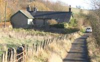 The remote Border Counties station at Tarset on 5 November 2007, more than 50 years after closure. View is south along the former station approach from the main road looking towards Reedsmouth, with the trackbed of the Riccarton Junction - Hexham line running along a cutting to the left of the privately owned 1861 station building. <br><br>[John Furnevel 05/11/2007]