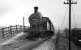 L&YR 2-4-2T 50651, with a 26D Bury shedplate on its smokebox, calls at the small Woodhill Road Halt on its way to Holcombe Brook on the last day of services. Conductor rails still in place alongside the line. (Does anyone have pictures of the electric trains on this branch?) I visited this site in December 2008 and found that not only has the station gone but also the embankment has made way for housing too, with the spoil apparently moved up the hill to fill in Brandlesholme Road cutting [see image 21238], where houses were also being built. Print credited to N R Knight. <br><br>[W A Camwell Collection (Courtesy Mark Bartlett) 04/05/1952]