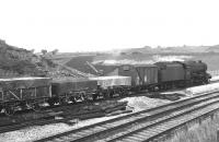 Stanier 8F 2-8-0 no 48169 brings a freight into Penrith off the Keswick line in September 1967 over the new railway bridge spanning the M6 motorway. Construction of the motorway itself is well underway in the background.<br>
<br><br>[Colin Miller 15/09/1967]