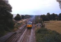 A class 50 is about to take a Waterloo to Exeter service through the closed (1966) station at Dinton, west of Salisbury, in May 1985.<br><br>[John McIntyre /05/1985]