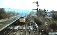 A class 47 approaches Haltwhistle with a Carlisle bound train in 1984. On the right is the remaining stub of the former Alston branch climbing towards the South Tyne viaduct.<br><br>[Colin Alexander //1984]