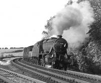A southbound freight leans into the curve at Eamont Bridge on the southern outskirts of Penrith in September 1967 behind Stanier 8F 2-8-0 no 48551. <br><br>[Colin Miller /09/1967]
