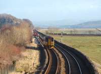 A Lancaster bound Northern <I>bubble car</I> 153360 heads for Arnside viaduct along the embankment with the Kent estuary alongside. Grange-over-Sands signal box is switched out at weekends giving a block section from Arnside to Ulverston.<br><br>[Mark Bartlett 17/01/2009]