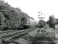 The 1516 Carnforth - Carlisle DMU passes the former Eamont Bridge Junction, just south of Penrith, in September 1967. The trackbed on the right is the remains of the south to west link from the Lancaster and Carlisle at Eamont Bridge Junction to the Cockermouth, Keswick & Penrith at Redhills Junction, put in by the North Eastern Railway in 1866 to provide through running between the east and west coasts via the Stainmore line. The link was closed in 1936.<br><br>[Colin Miller 25/09/1967]