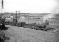 Ex-NB <I>Scott</I> class 4-4-0 no 62418 <I>The Pirate</I> about to run into Inverkeithing station in 1958 with a train for Edinburgh off the Dunfermline line. A second train, on the Fife Coast route, can be seen standing at signals on the approach to Inverkeithing East Junction in the background. The area in the middle distance is now an industrial estate.<br><br>[Robin Barbour Collection (Courtesy Bruce McCartney) //1958]