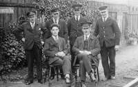 A posed photograph of the staff at Coalburn station, Lanarkshire, around 1931. The Station Master is seated on the right with Tom Steele, then station clerk, in the other chair. The photograph was taken some two years before Tom Steele was appointed Station Master at Crossmyloof.<br><br>[Ian Steele Collection //1931]