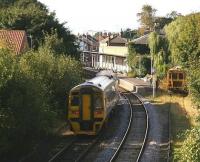 A Bridlington - Sheffield service, formed by 158817, runs into Driffield station on 1 October 2008, passing a stabled tamper almost hidden in the undergrowth.<br><br>[John Furnevel 01/10/2008]