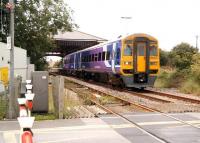 A Northern Trains 158 pulls away from Filey in September 2008 and is about to traverse the level crossing over the A1039 with a service for Scarborough.<br><br>[John Furnevel 28/09/2008]