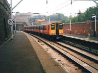314 209 seen at Bridgeton in September 1998 on a service to Coatbridge Central, as a bus passes the station entrance on London Road heading for the city centre.  <br><br>[David Panton 11/09/1998]