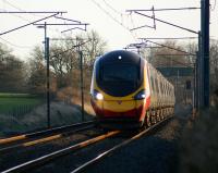 A northbound Pendolino approaches the footbridge at Woodacre, Lancs, on 24 January 2009.<br><br>[John McIntyre 24/01/2009]