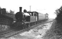 Cam Camwell's visits to the Holcombe Brook branch were made at weekends and so the pick up freight workings were not captured. At this time they would have been in the hands of L&Y A Class 0-6-0 locomotives although later Bury shed had an allocation of LMS 2MT<br>
2-6-0s that were used. If anyone has any pictures of these goods trains that can be put on the website I know our Editor will be pleased to receive them. Here L&Y 2-4-2T 50655, with its 26D (later 9M) shedplate, stands at the terminus on the last weekend of passenger services. Although the background detail in this picture is not clear the start of the 1:40 gradient can be seen beyond the signal box. [See image 29490] for a view of the same location taken around 1905.<br><br>[W A Camwell Collection (Courtesy Mark Bartlett) 03/05/1952]
