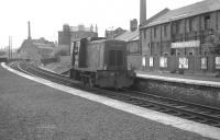 An early NBL 0-4-0 diesel hydraulic no D2705 has just turned off the ECML at Abbeyhill Junction in July 1963 and is seen running north through Abbeyhill station. One of a class first introduced in 1953, the locomotive was originally numbered 11705 by BR.<br><br>[Colin Miller 18/07/1963]