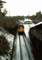 A Glasgow-bound West Highland Line service pulls into Helensburgh Upper station on a cold winter's day in 1979.<br><br>[Johnny Trippick //]