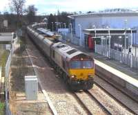 EWS 66004 passes through Alloa on its way back to Hunterston on 4 March 2009 with Longannet empties, dwarfing the 3-car 170 at the station platform forming the next service to Glasgow Queen Street.<br><br>[David Panton 04/03/2009]