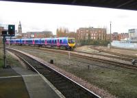 185149 arrives at Bolton station on 05 March 2009 from the Preston direction with a service to Manchester Airport. The tracks curving away to the right come together around the corner and form the single track route to Blackburn.<br><br>[John McIntyre 05/03/2009]