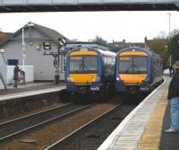 170404 on the right, calls at Inverkeithing after a refit at Babcock Engineering Services, Rosyth Dockyard (see image 22278). New lighting is evident, however the unit has been involved in a <I>rough shunt</I>.<br><br>[Brian Forbes 09/03/2009]