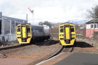 Two English exiles pass at Larbert North box on 4 March: 158 871 in Alphaline silver livery heads for Dunblane and while ex-SWT 158 786 approaches Larbert station with an Edinburgh service. The semaphore is in odd but pleasing contrast with the swish Network Rail Training School to the left. Last year semaphores gave way to LED MAS to the south at Larbert Junction and at Plean Junction to the north, where the very tall box (image 19254) is now demolished. There are LN (Larbert North) plates on the signals on their former patch.<br><br>[David Panton 04/03/2009]