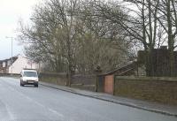 Main Road in Elderslie looking west in March 2009. On the right stand the bricked up remains of the entrance to Elderslie station, which was closed in 1966. <br><br>[Graham Morgan 03/03/2009]