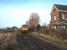 A York, Harrogate Leeds service with 144004 hurries through the closed station at Marston Moor on the single line section between Poppleton and Hammerton.  The home signal protects the crossing here with the distant being for nearby Hessay. View west towards Hammerton and Knaresborough.<br><br>[Mark Bartlett 15/12/2008]