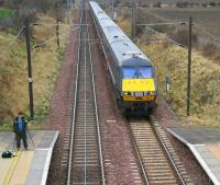 <I>Waiting for Tornado</I>... a photographer with an interesting dual-camera rig awaits the arrival of 60163 with the <I>Auld Reekie Express</I> at Wallyford on 28 February 2009. Meantime an ECML service to Kings Cross is about to run through the station on the up line.<br><br>[John Furnevel 28/02/2009]