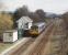 A <I>Then and Now</I> comparison with [See image 22975] shows Burscough Bridge Junction signal box still in use, albeit now controlling colour light signals. 142027 is heading towards Wigan and will shortly pass under the Preston to Ormskirk line. The two chord formations are still in place and the subject of proposals for reinstatement of the track allowing through trains from Preston to Southport and the extension of the Ormskirk electric trains to Burscough Bridge Interchange.  <br><br>[Mark Bartlett 17/03/2009]